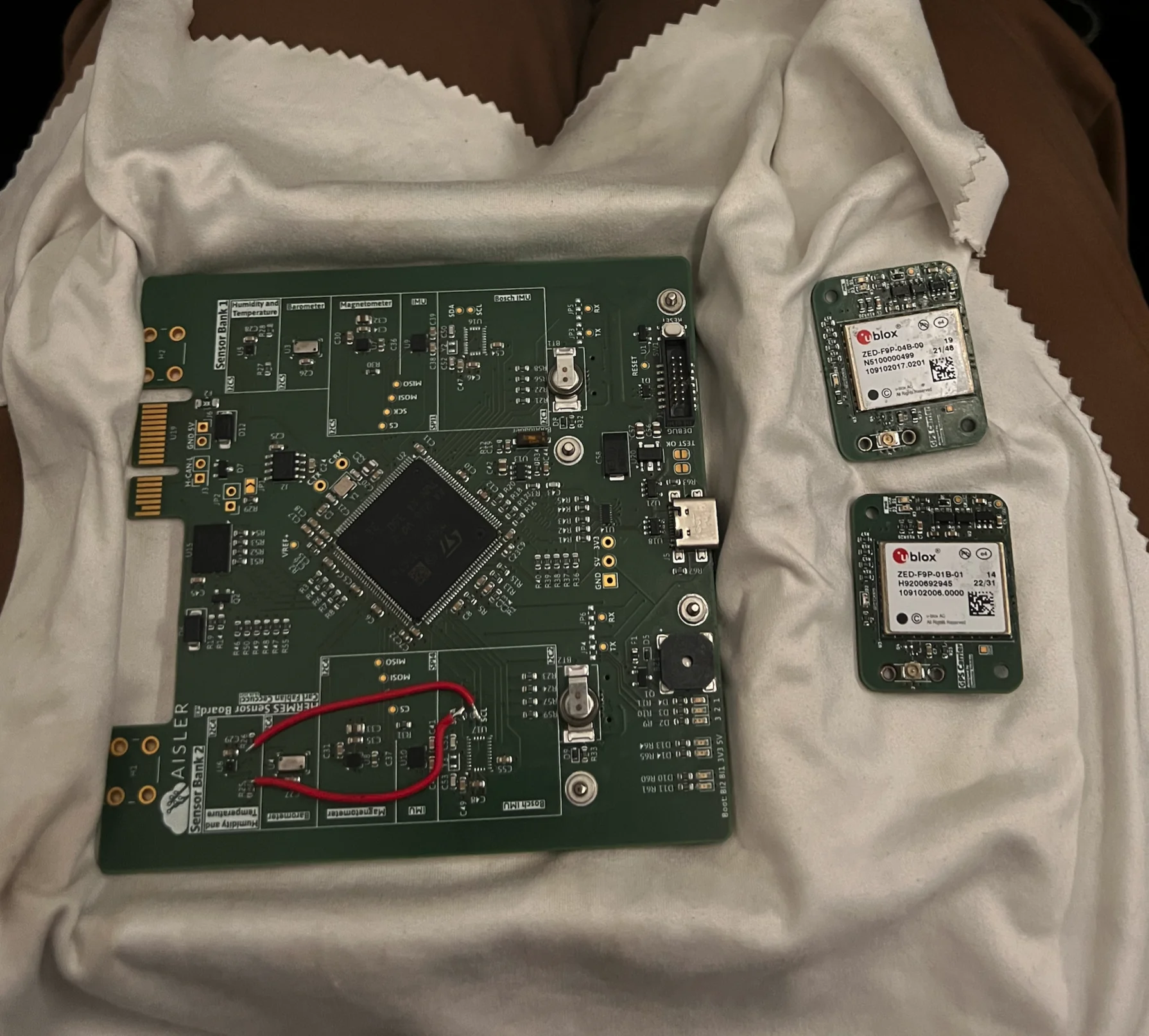 Sensor carrier V2 next to the two ZED-F9P GPS daughterboards before integration